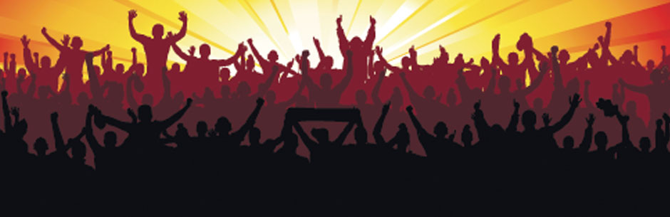 Sports fans celebrate looking into a sunset