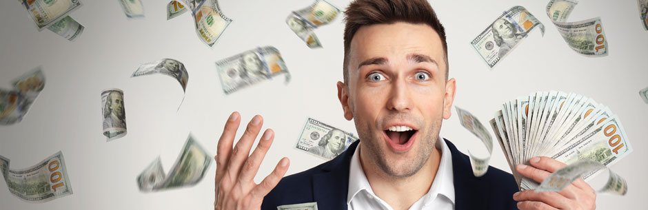 A man looks happy in a shower of dollar notes