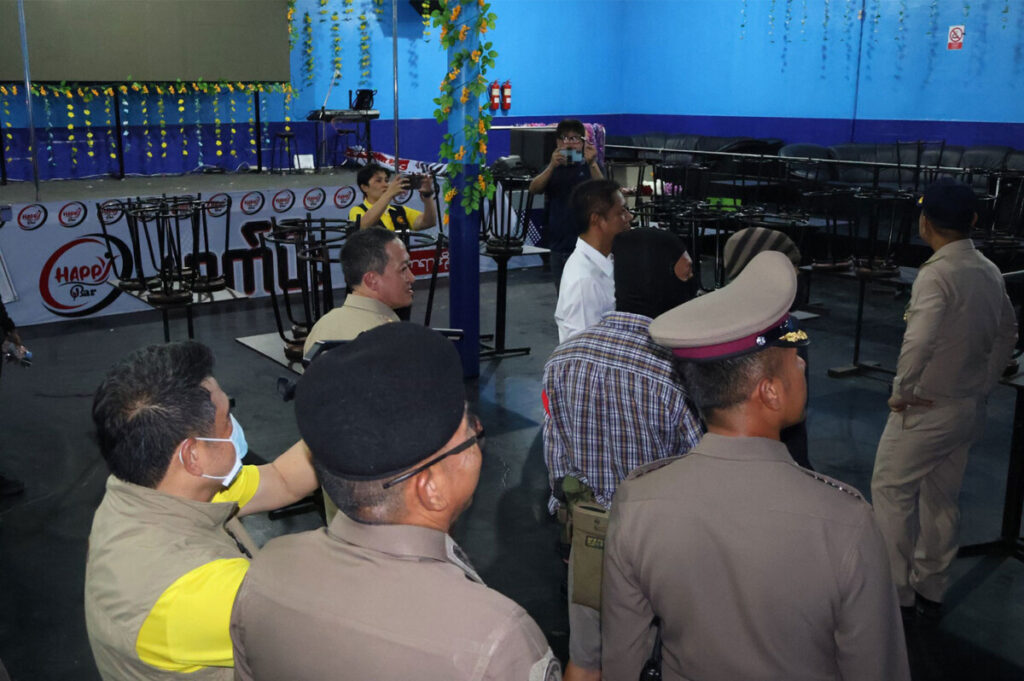 Police inspect a suspected illegal gambling den in Samut Sakhon, Thailand.